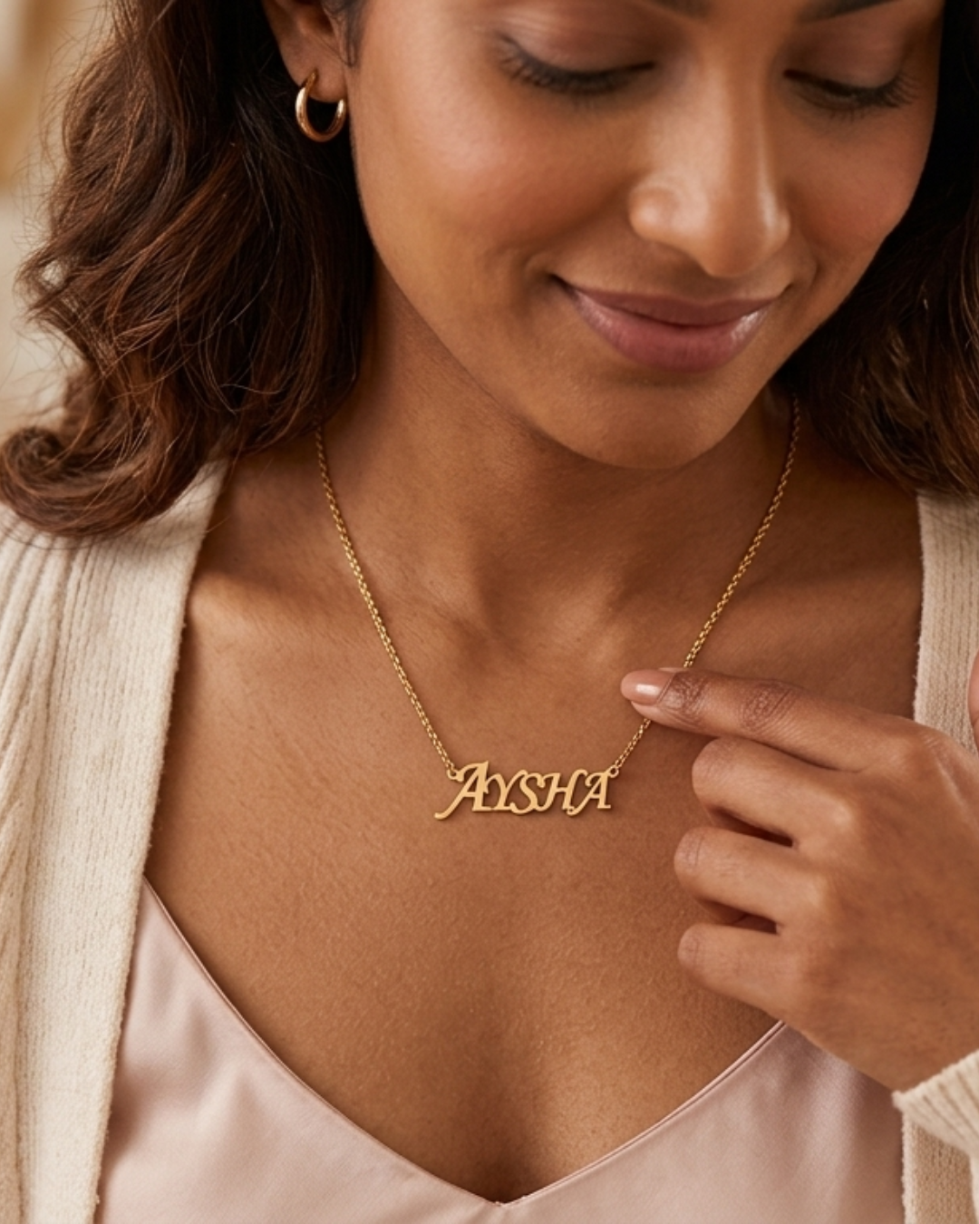 Woman wearing a gold 'Ayesha' necklace