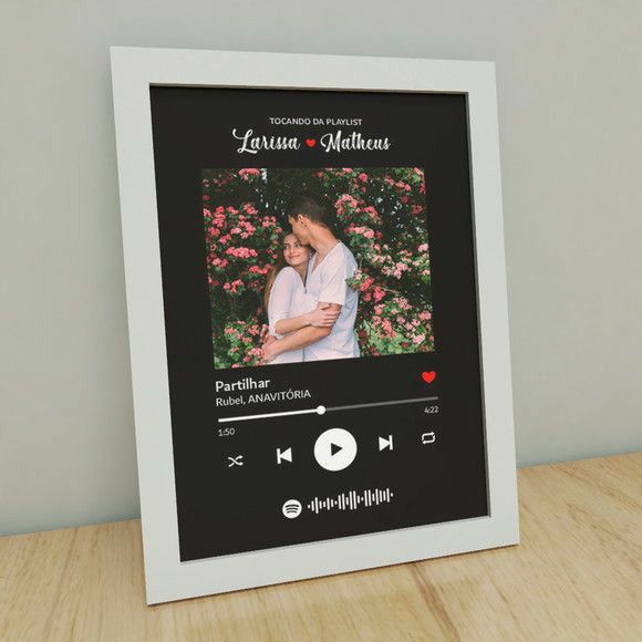 Framed artwork with a couple's photo and music player interface on a black background