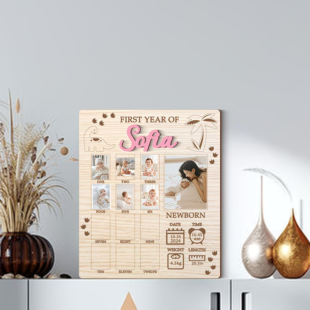 Wooden photo collage board with baby milestone photos on a white shelf.