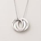 A silver chain necklace with three interlocking circular pendant rings engraved with the names Michael, Alice, and the date 2025.5.