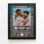 Digital photo frame displaying a couple on a beach with a music player interface.
