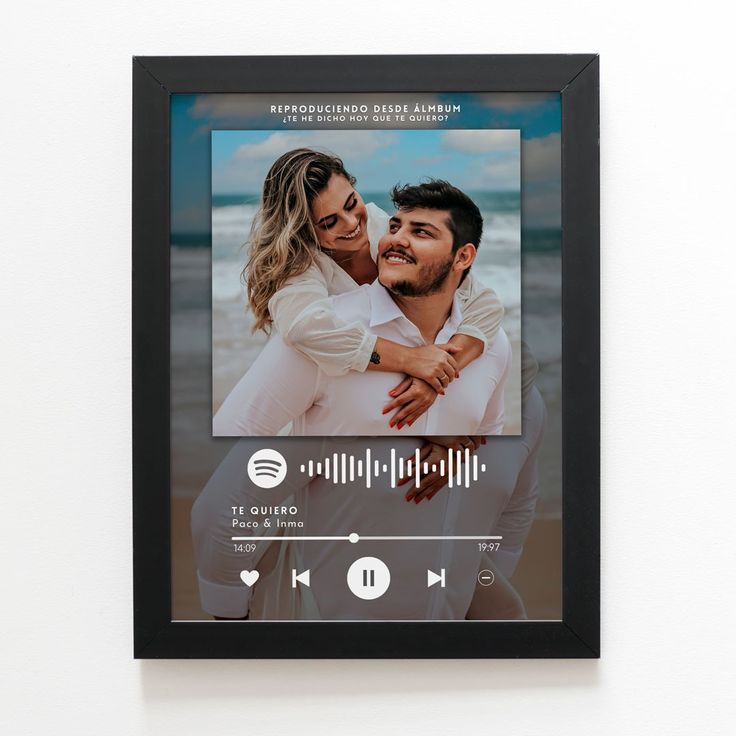 Digital photo frame displaying a couple on a beach with a music player interface.